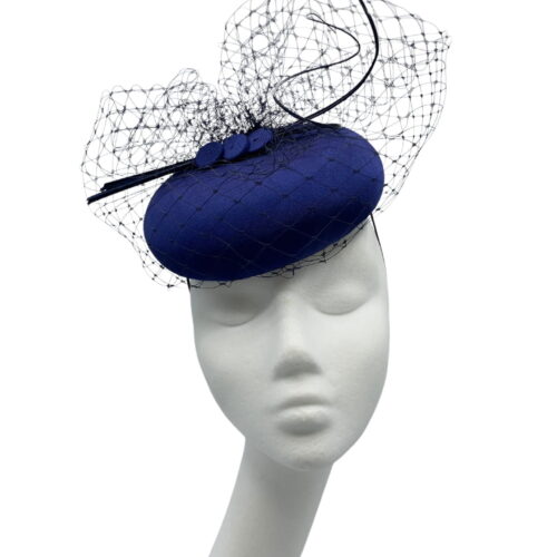 Simple beautiful navy headpiece with navy veiling overlay and finished with matching navy quills.